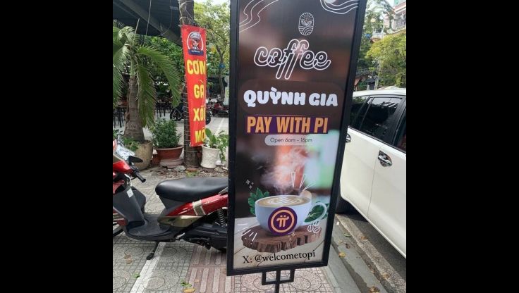 "Coffee shop sign showing 'Pay with Pi' option"